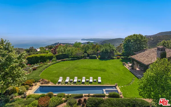 a view of a swimming pool with a yard
