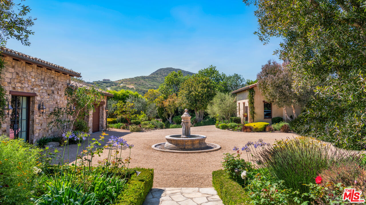2900 Corral Canyon Road Malibu, CA 90265 - Photo 8 of 48 a front view of a house with a yard and fountain