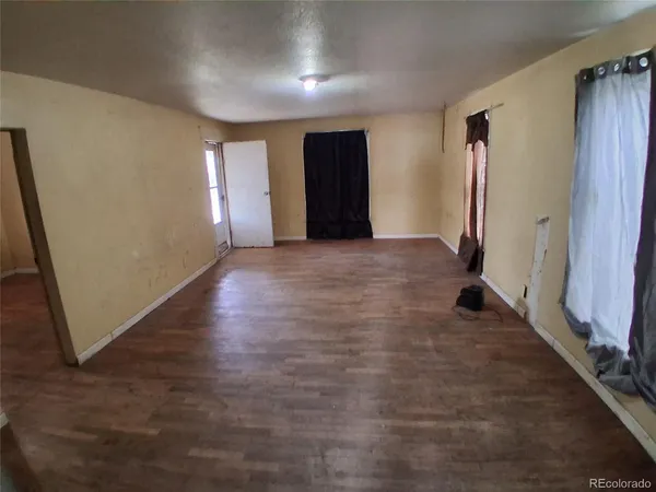 an empty room with windows and entrance