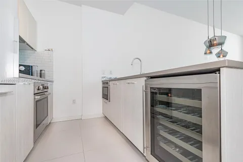 a view of a storage and utility room with washer and dryer