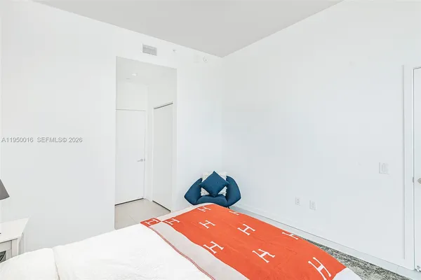 a bedroom with a bed and a hallway