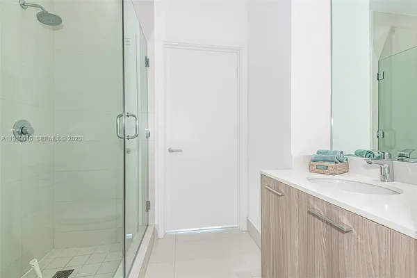 a bathroom with a sink a mirror and shower