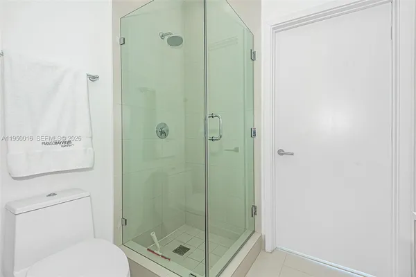 a bathroom with a shower a toilet and a sink