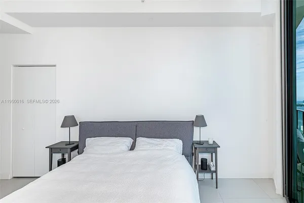 a bedroom with a bed and a table