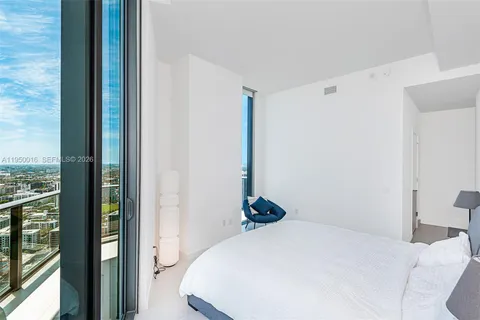 a bedroom with a bed and a view of closet