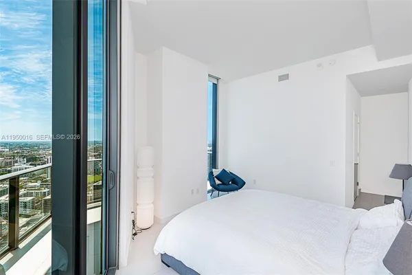 a bedroom with a bed and a view of closet