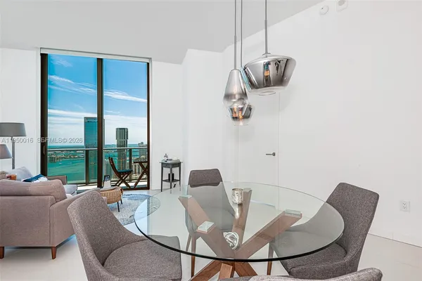 a living room with furniture and a floor to ceiling window