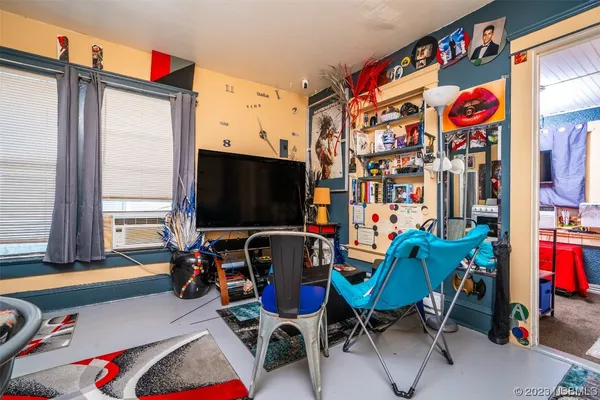 a room with furniture a flat screen tv and a window