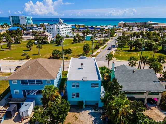 an aerial view of multiple houses with yard