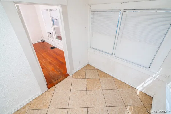 a view of an empty room and wooden floor