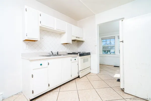 a kitchen with a sink cabinets and a window