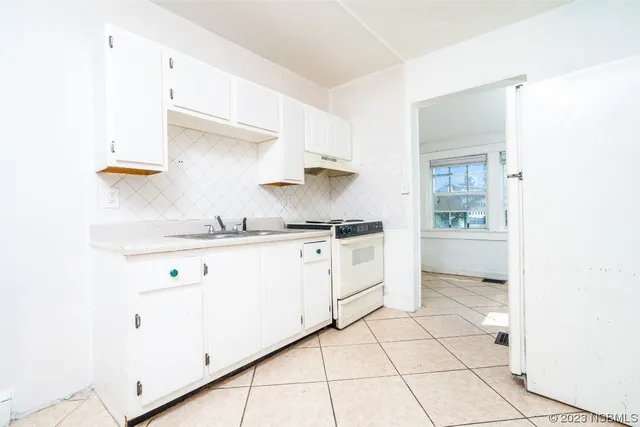 a kitchen with a sink cabinets and a window