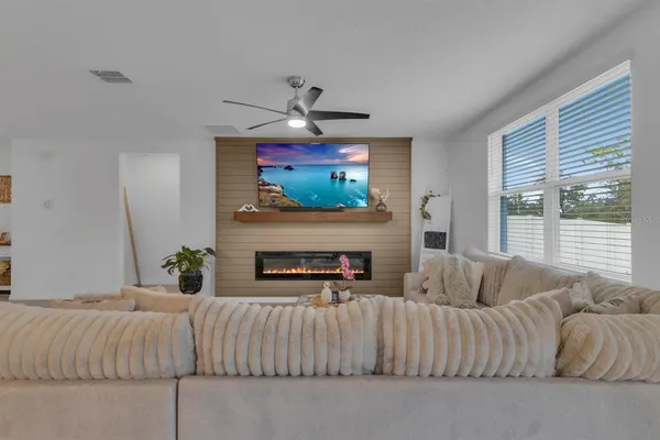 a living room with furniture and kitchen view