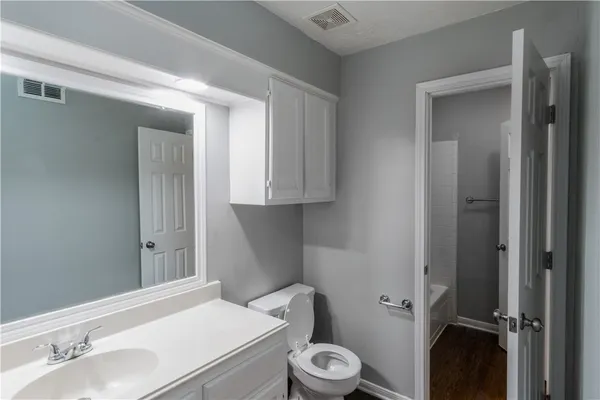 a bathroom with a sink a toilet and vanity