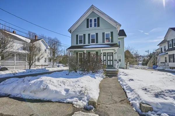a view of a house with a snow in the yard