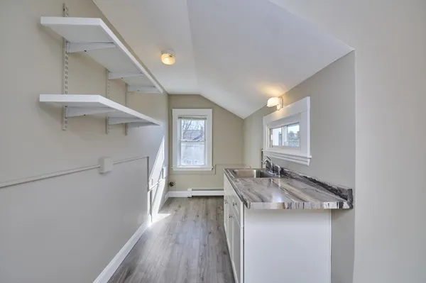 a view of a room with wooden floor and chair