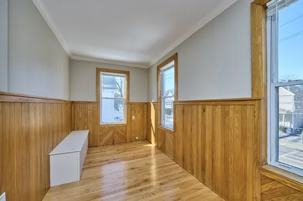 a view of empty room with wooden floor
