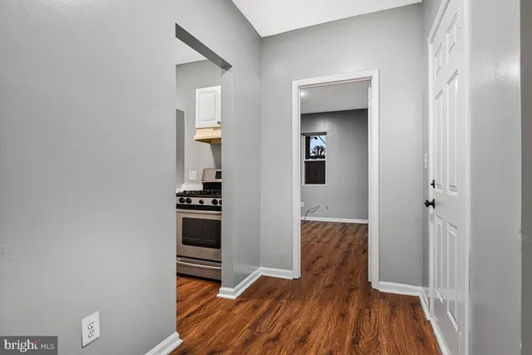 a view of a hallway view with wooden floor and staircase