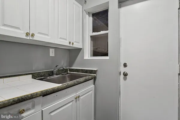 a kitchen with a sink and cabinets