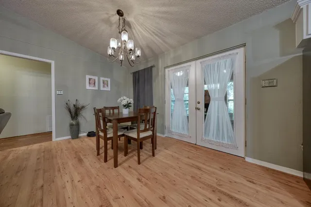 a view of a dining room with furniture and chandelier