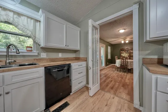 a kitchen with granite countertop a stove a sink and a refrigerator