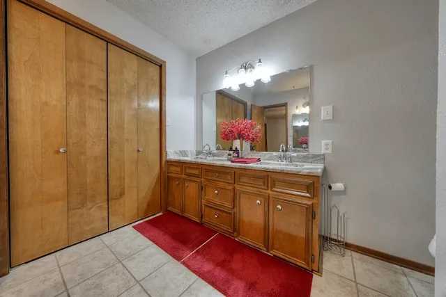 a spacious bathroom with a mirror and a shower