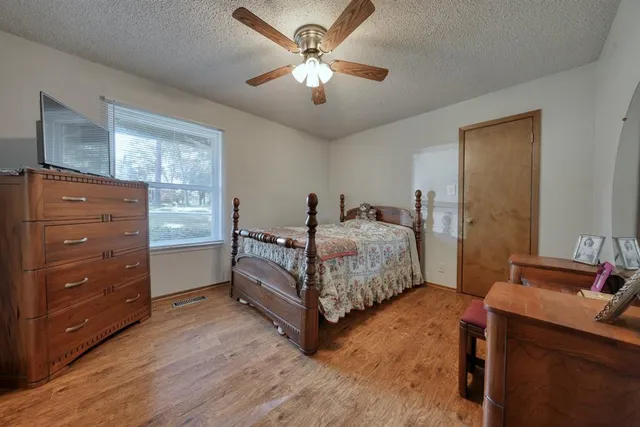 a bedroom with a bed and a chandelier