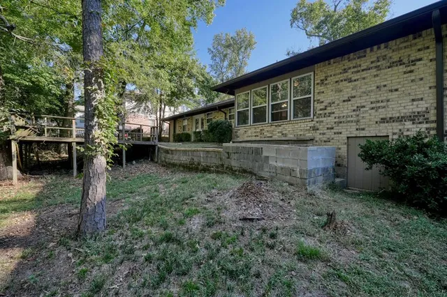a backyard of a house with a garden and barbeque oven