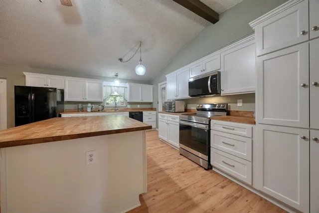 a kitchen with stainless steel appliances white cabinets and a sink