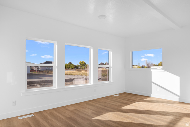 1510 West 600 North, Unit 4A Mapleton, UT 84664 - Photo 5 of 23 Unfurnished room with light wood-style flooring and beamed ceiling