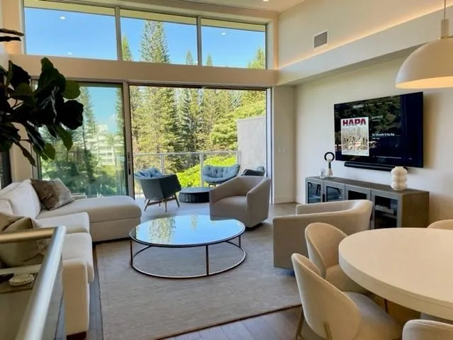 a living room with couches a coffee table and a flat screen tv