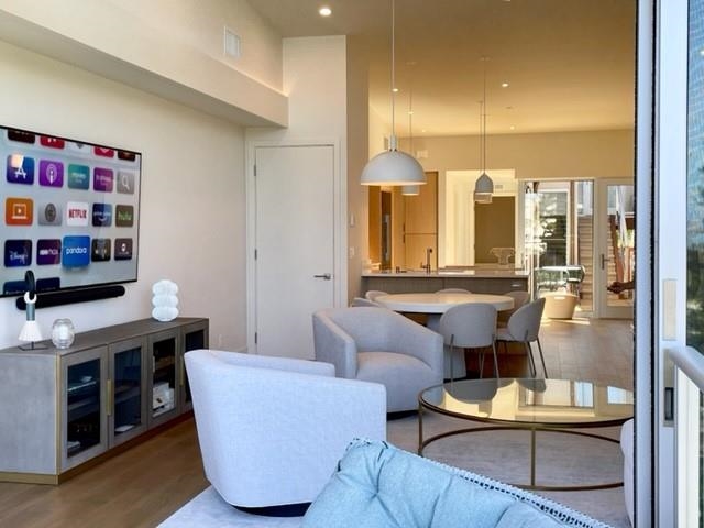 161 Holomoana Way, Unit 102 Kihei, HI 96753 - Photo 14 of 34 a living room with furniture and a fireplace