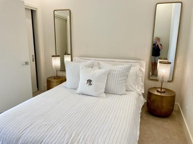 161 Holomoana Way, Unit 102 Kihei, HI 96753 - Photo 18 of 34 a bedroom with a bed a mirror and a lamp