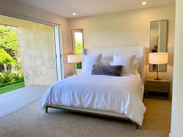 a bedroom with a bed and a lamp