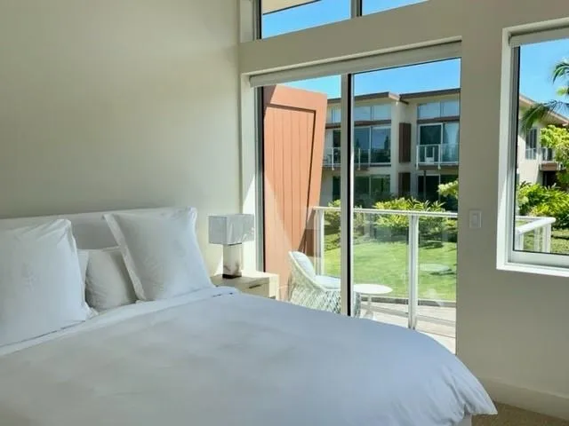 a bed room with a bed and a chair