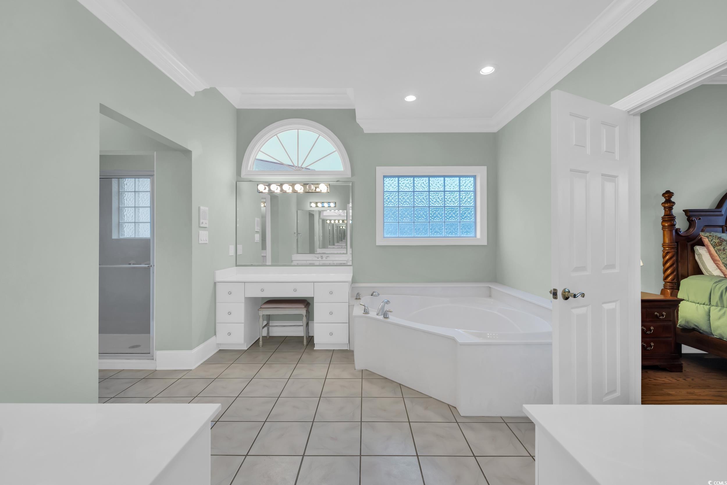1473 Doar Point Myrtle Beach, SC 29577 - Photo 13 of 40 Bathroom with ornamental molding, a bath, tile patterned flooring, vanity, and connected bathroom