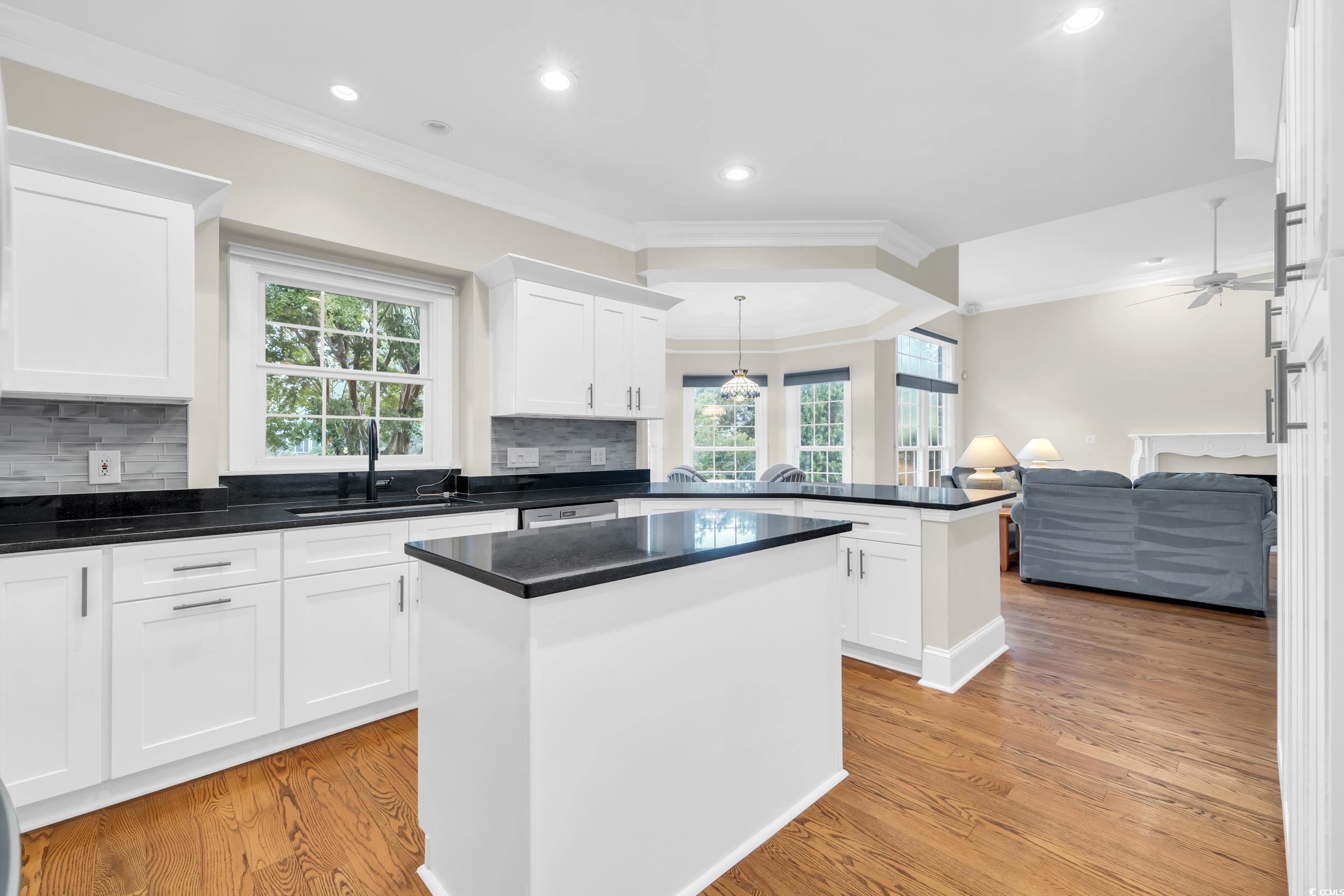 1473 Doar Point Myrtle Beach, SC 29577 - Photo 22 of 40 Kitchen with ornamental molding, a peninsula, healthy amount of natural light, backsplash, and recessed lighting