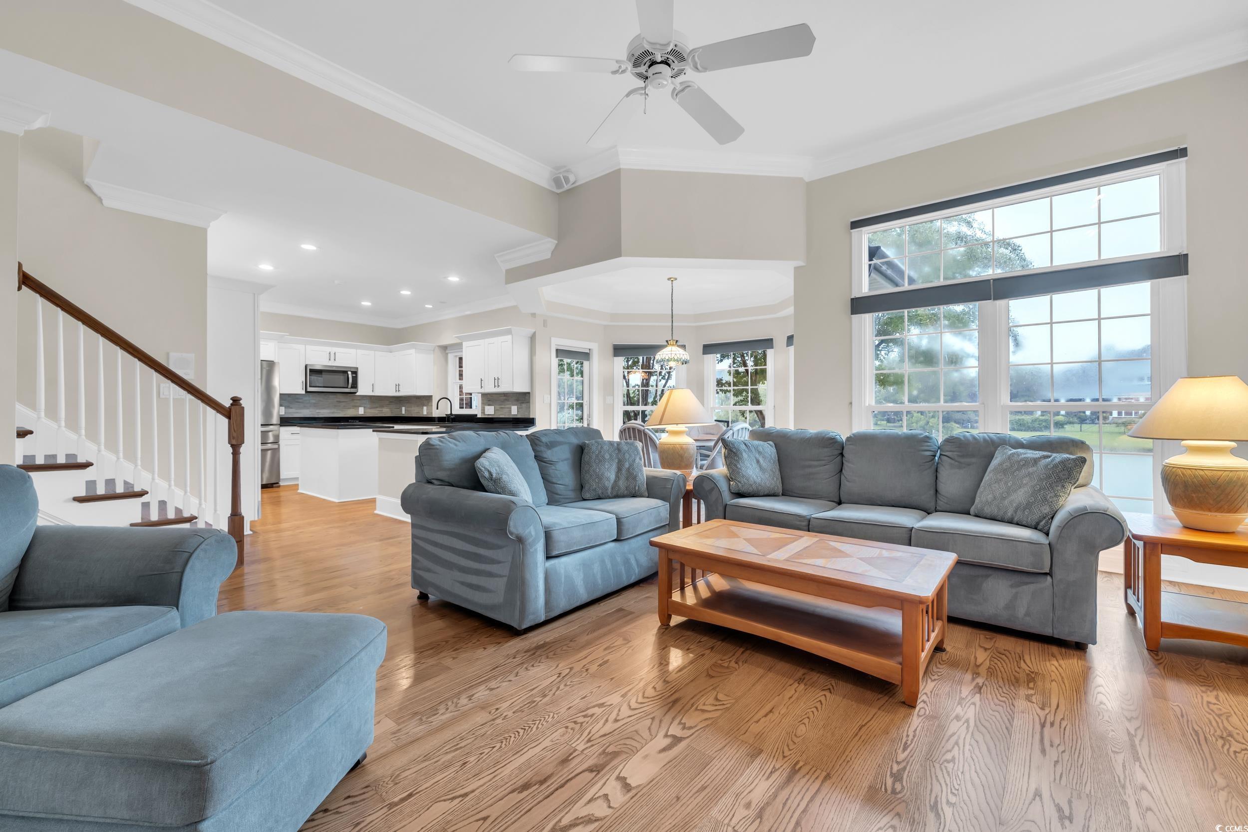 1473 Doar Point Myrtle Beach, SC 29577 - Photo 25 of 40 Living area featuring light wood-style flooring, crown molding, stairs, and ceiling fan