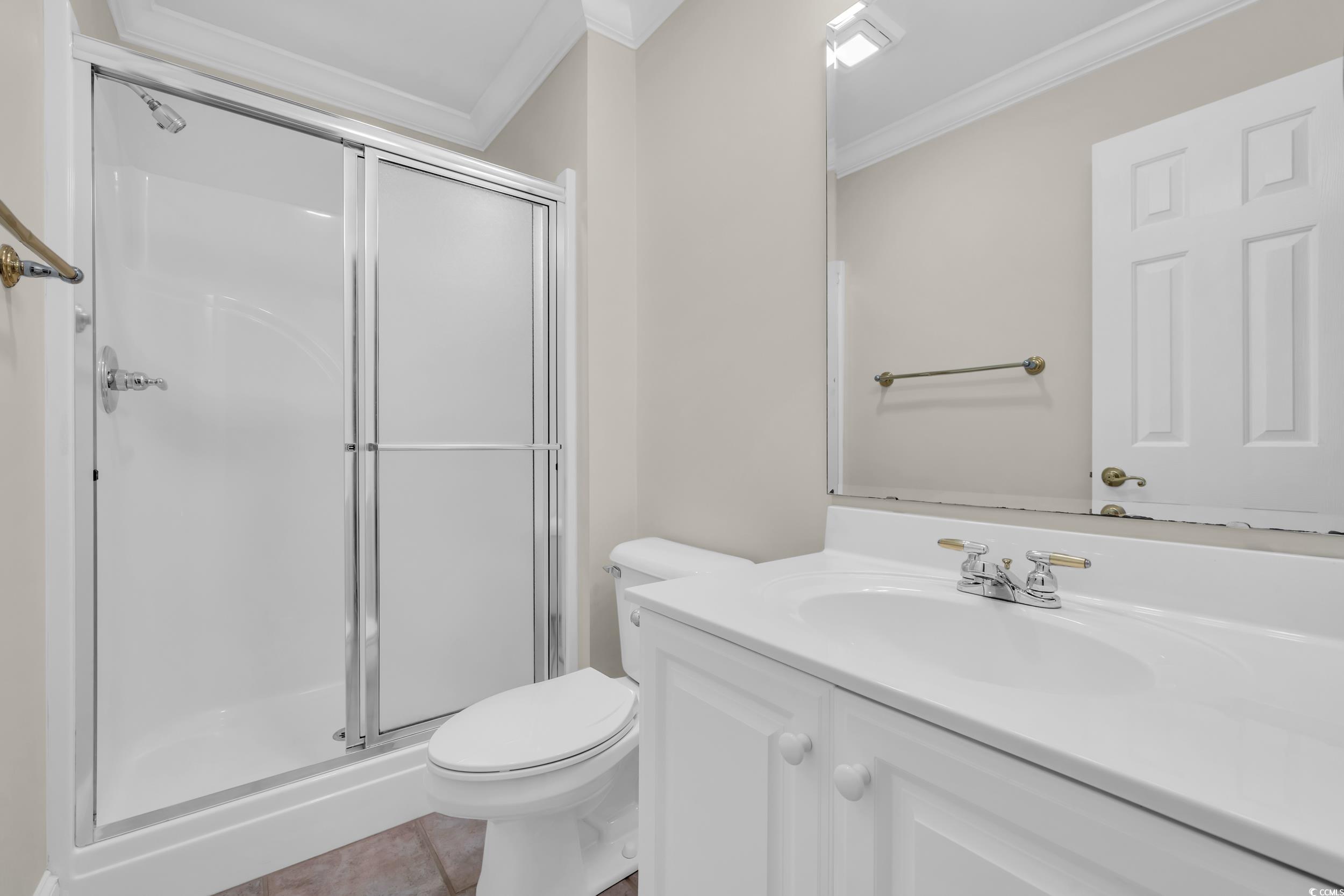 1473 Doar Point Myrtle Beach, SC 29577 - Photo 27 of 40 Full bathroom featuring ornamental molding, vanity, a stall shower, and tile patterned floors