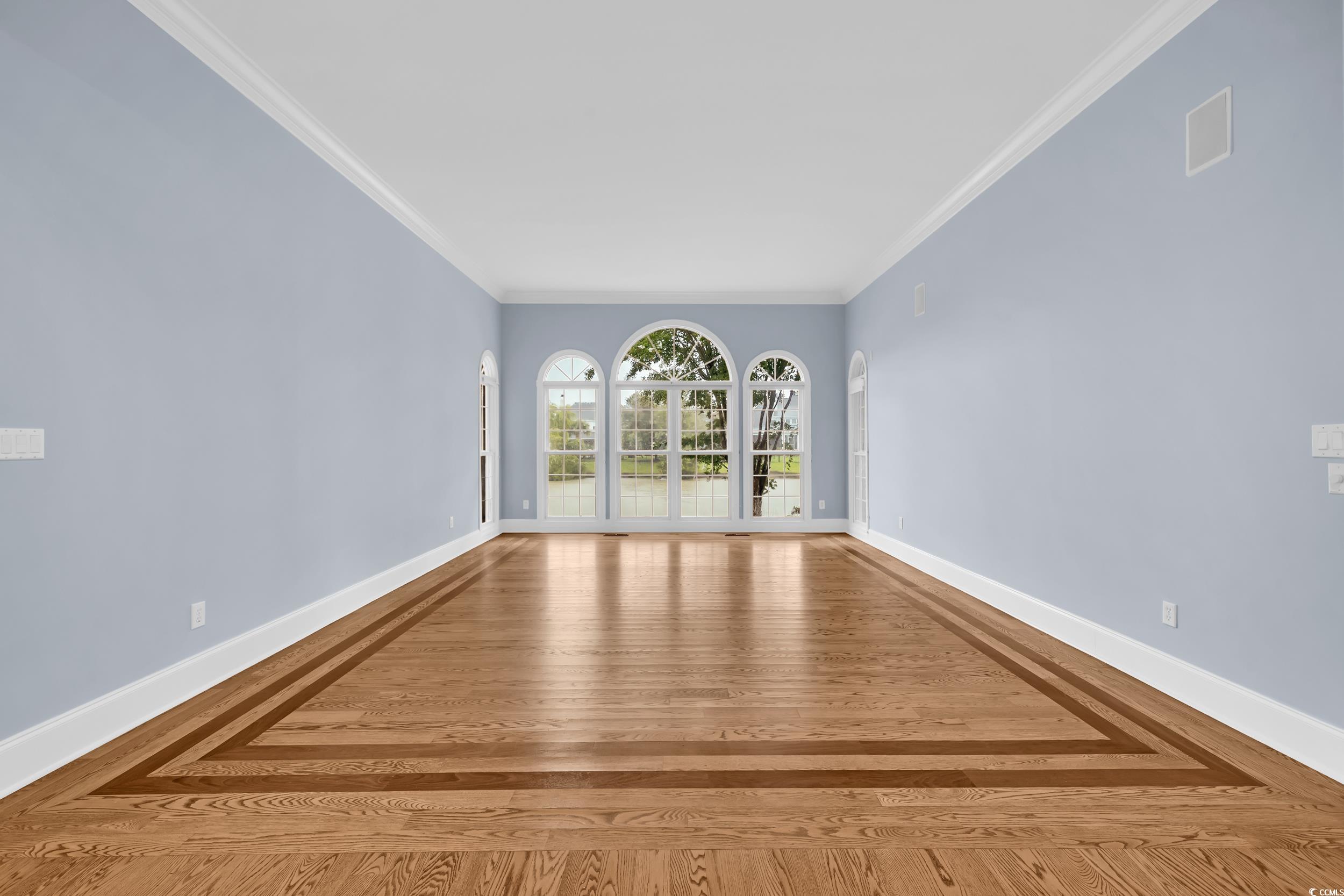 1473 Doar Point Myrtle Beach, SC 29577 - Photo 8 of 40 Empty room featuring crown molding and wood finished floors