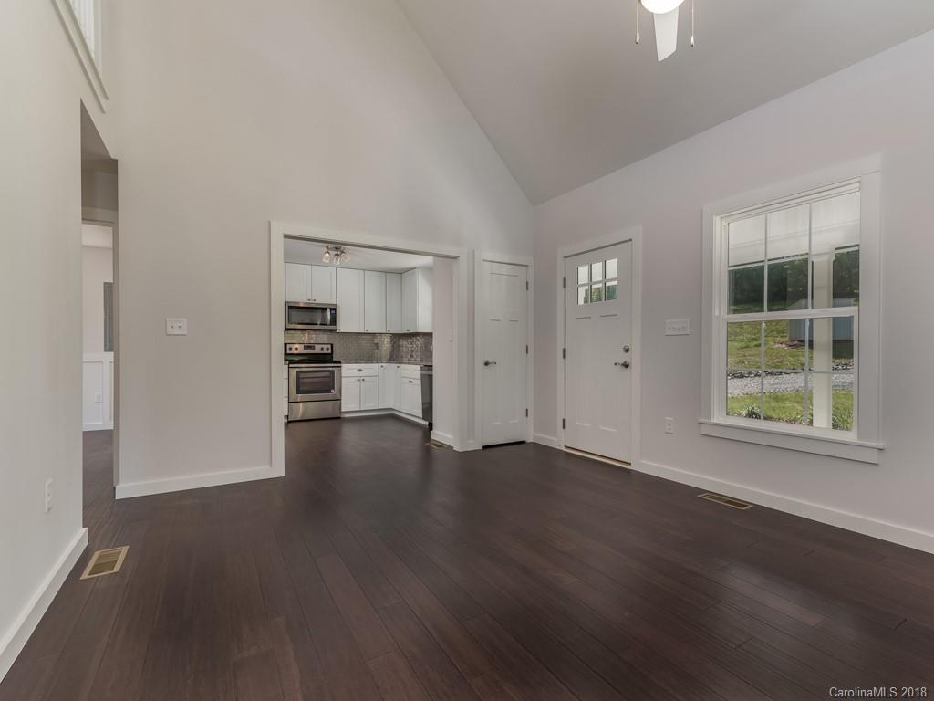 4924 Hudlow Road Union Mills, NC 28167 - Photo 13 of 34 an empty room with wooden floor kitchen view and windows