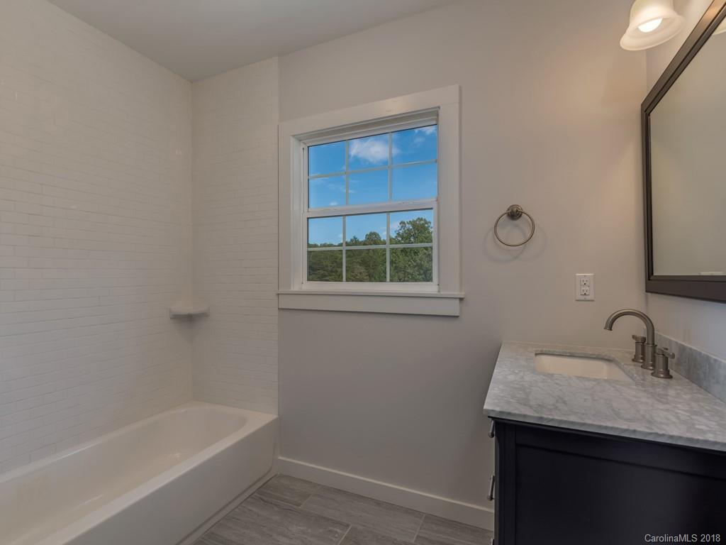4924 Hudlow Road Union Mills, NC 28167 - Photo 16 of 34 a bathroom with a granite countertop sink a toilet and shower