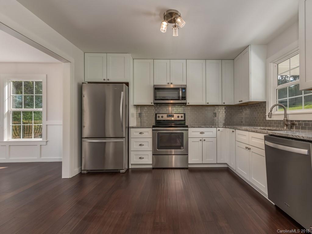 4924 Hudlow Road Union Mills, NC 28167 - Photo 7 of 34 a kitchen with stainless steel appliances a refrigerator sink and cabinets