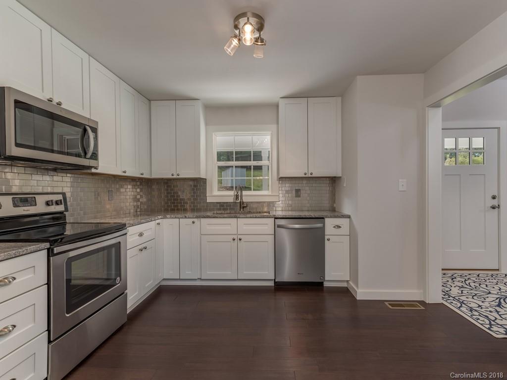 4924 Hudlow Road Union Mills, NC 28167 - Photo 8 of 34 a kitchen with stainless steel appliances granite countertop a stove a sink dishwasher and a microwave oven with cabinets