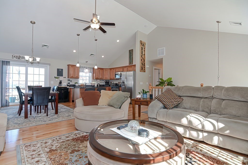 1066 Spencer Street Fall River, MA 02721 - Photo 12 of 35 a living room with furniture kitchen and a chandelier
