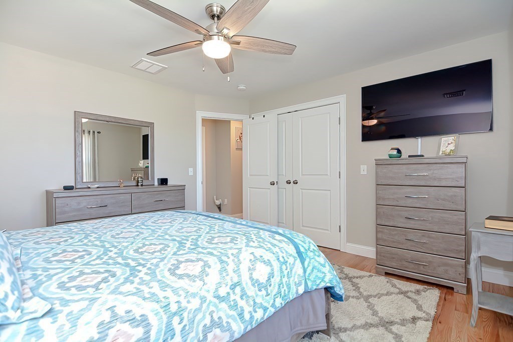 1066 Spencer Street Fall River, MA 02721 - Photo 14 of 35 a bedroom with a bed and a flat screen tv
