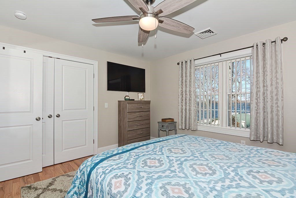 1066 Spencer Street Fall River, MA 02721 - Photo 15 of 35 a bedroom with a bed and a flat screen tv