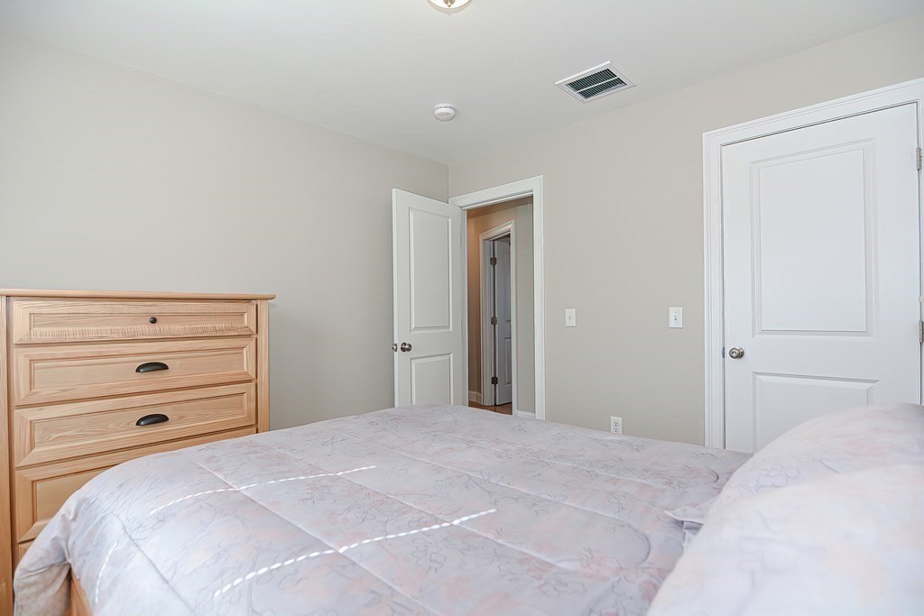 1066 Spencer Street Fall River, MA 02721 - Photo 18 of 35 a bedroom with a bed and a dresser