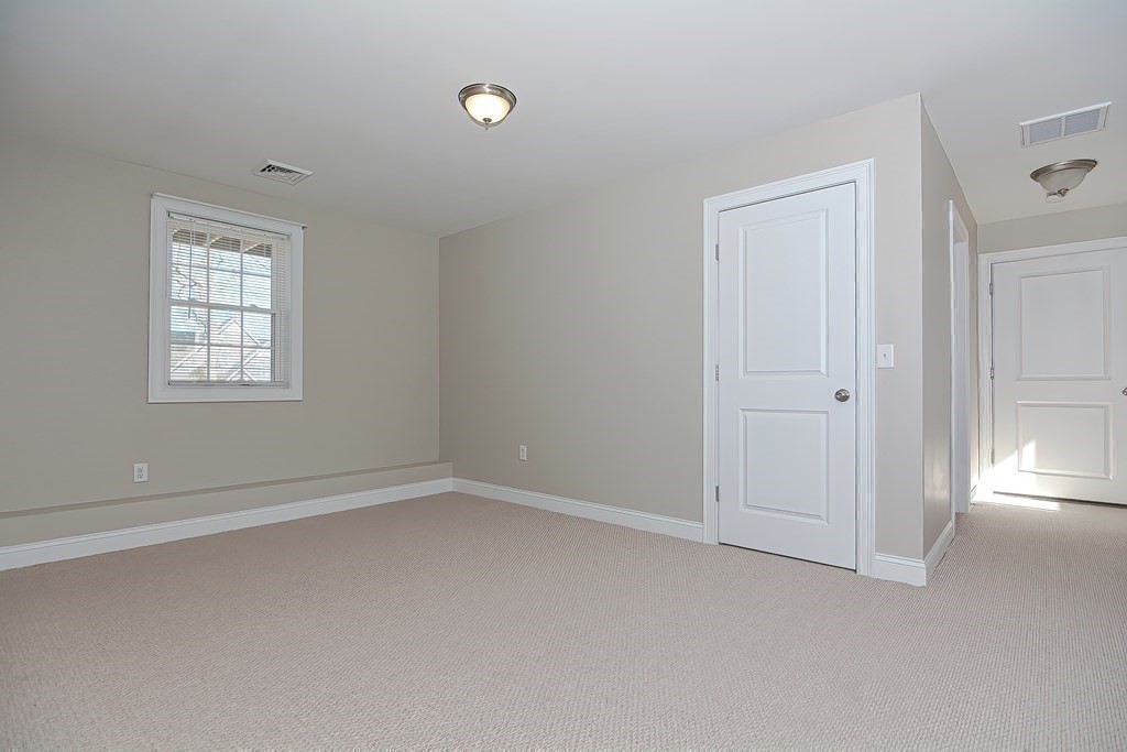 1066 Spencer Street Fall River, MA 02721 - Photo 20 of 35 an empty room with windows and closet