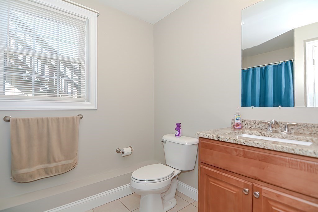 1066 Spencer Street Fall River, MA 02721 - Photo 23 of 35 a bathroom with a sink toilet and a window